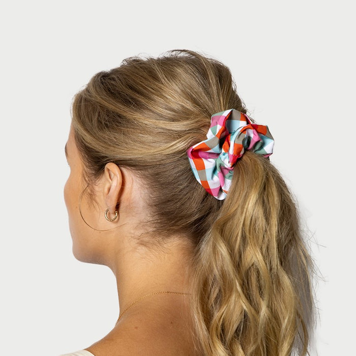 Woman wearing waterproof gingham scrunchie 