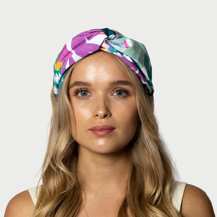 Woman wearing abstract floral print knotted waterproof headband