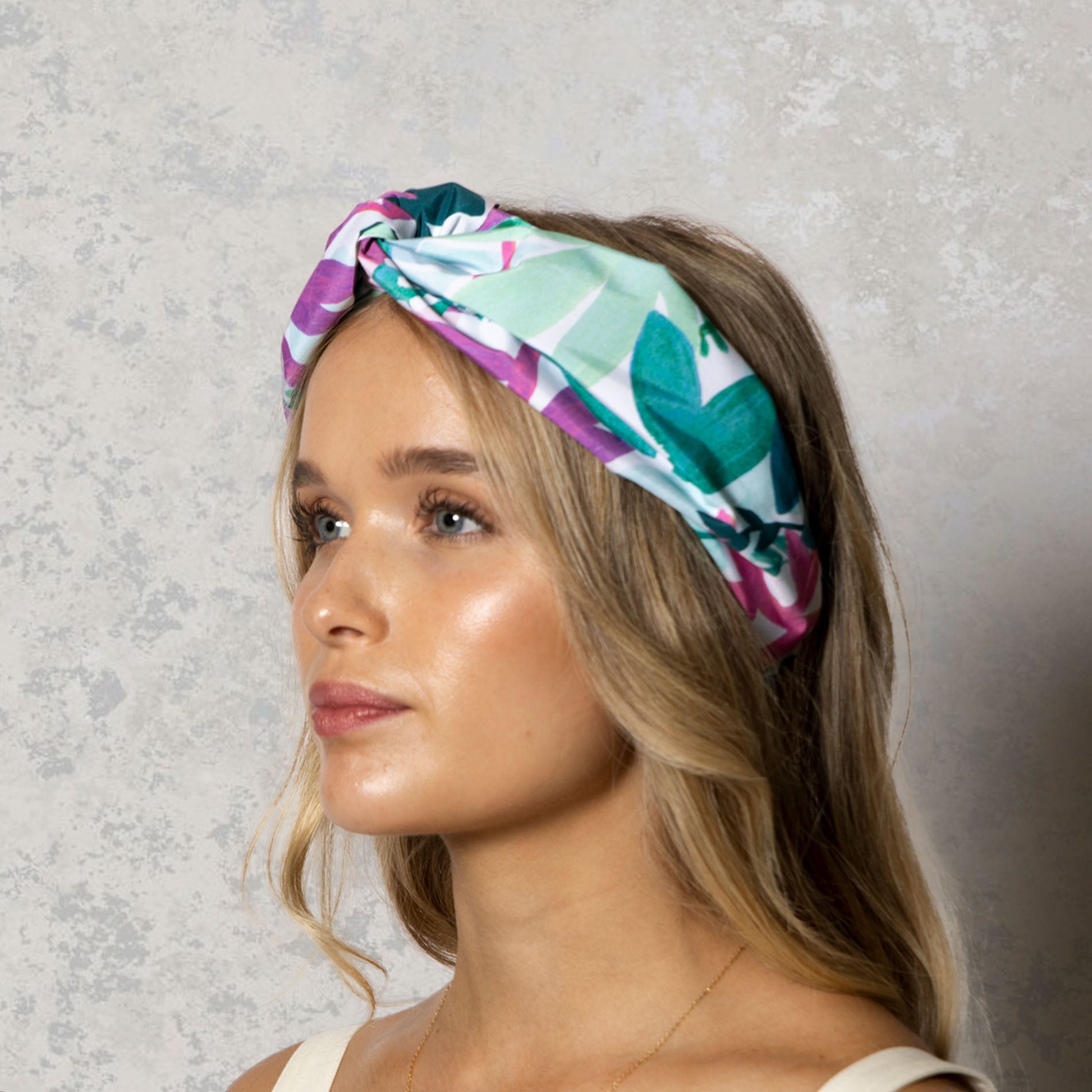 Woman wearing abstract floral waterproof knotted headband